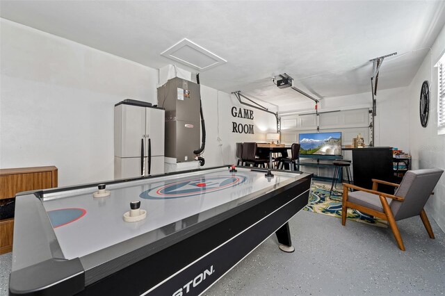 3485 Floral Dr, Largo, FL 33771 - rec room featuring speckle patterned floor, a garage, and attic access