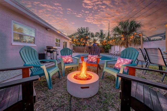 3485 Floral Dr, Largo, FL 33771 - patio terrace at dusk with an outdoor fire pit and a fenced backyard