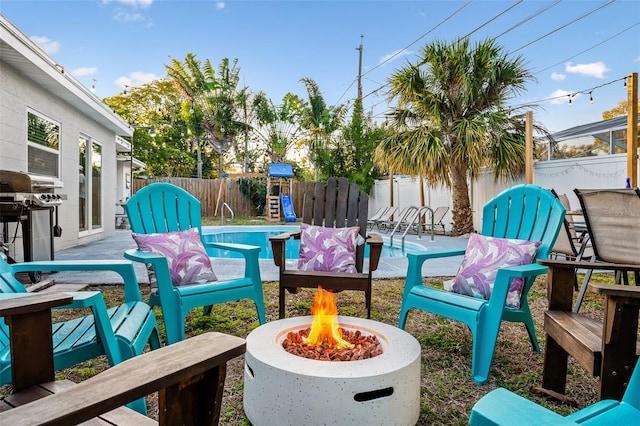 3485 Floral Dr, Largo, FL 33771 - fenced backyard featuring a fire pit, a patio area, and grilling area
