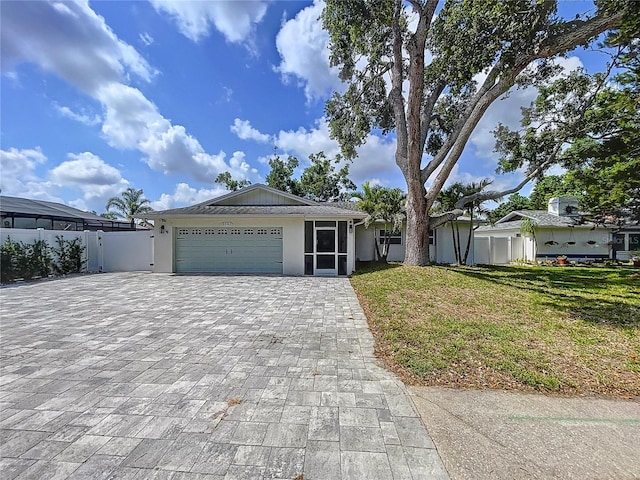9580 130th Ave, Largo, FL 33773 - ranch-style house featuring decorative driveway, an attached garage, and stucco siding