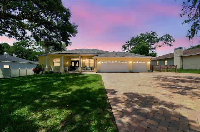 10306 Shalimar Wood Dr, Thonotosassa, FL 33592 - single story home featuring an attached garage, decorative driveway, stucco siding, and covered porch