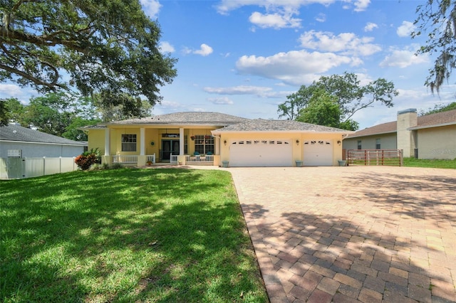10306 Shalimar Wood Dr, Thonotosassa, FL 33592 - single story home with covered porch, a garage, decorative driveway, and stucco siding