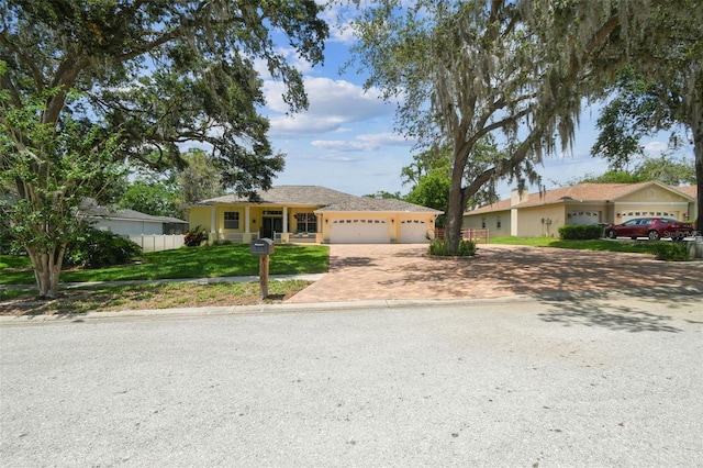 10306 Shalimar Wood Dr, Thonotosassa, FL 33592 - ranch-style house with decorative driveway and an attached garage