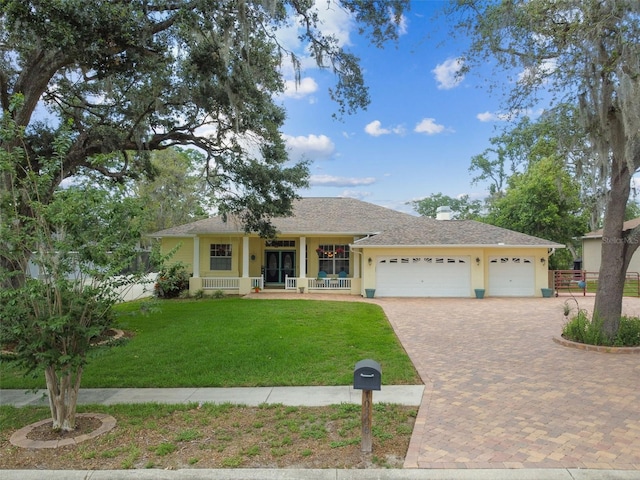 10306 Shalimar Wood Dr, Thonotosassa, FL 33592 - ranch-style home featuring a garage, covered porch, and decorative driveway