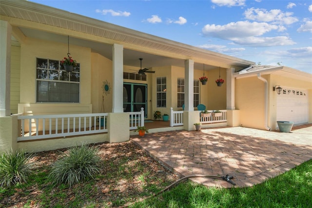 10306 Shalimar Wood Dr, Thonotosassa, FL 33592 - entrance to property featuring covered porch, stucco siding, ceiling fan, a garage, and driveway