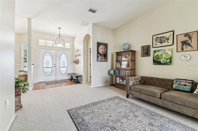 10306 Shalimar Wood Dr, Thonotosassa, FL 33592 - foyer entrance with arched walkways, carpet, and baseboards