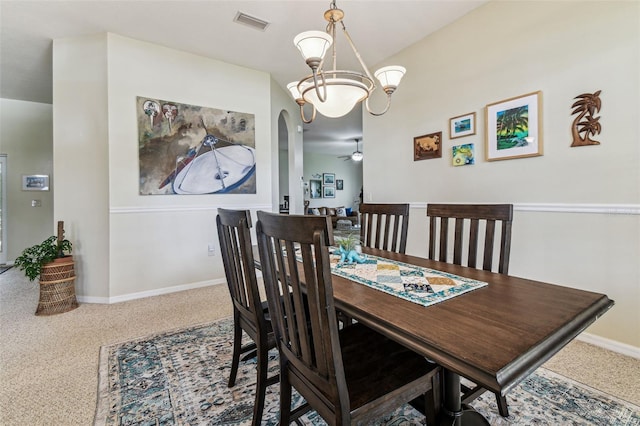 10306 Shalimar Wood Dr, Thonotosassa, FL 33592 - carpeted dining area featuring a chandelier, baseboards, a ceiling fan, and arched walkways
