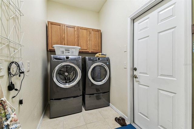 10306 Shalimar Wood Dr, Thonotosassa, FL 33592 - laundry room with cabinet space, light tile patterned floors, washer and dryer, and baseboards