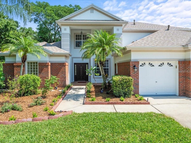 6127 Cezanne Ave, Lutz, FL 33558 - view of front facade featuring a garage, brick siding, driveway, and roof with shingles