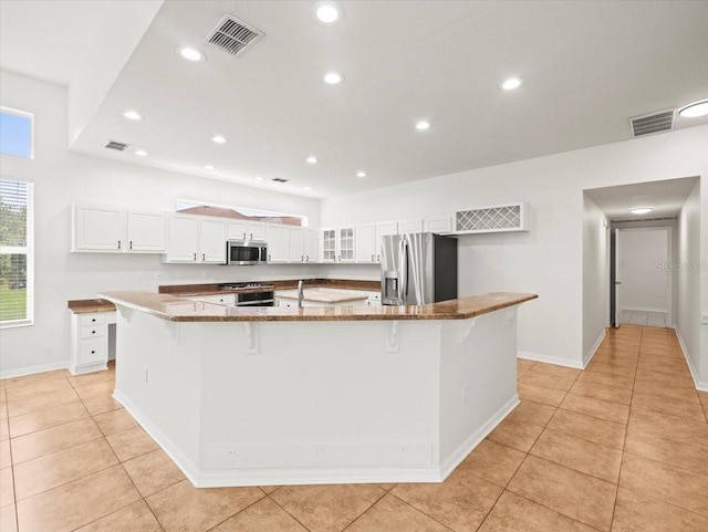 6127 Cezanne Ave, Lutz, FL 33558 - kitchen with stainless steel appliances, white cabinets, healthy amount of natural light, and recessed lighting