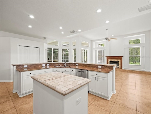 6127 Cezanne Ave, Lutz, FL 33558 - kitchen with a ceiling fan, a spacious island, stainless steel dishwasher, light tile patterned flooring, and recessed lighting