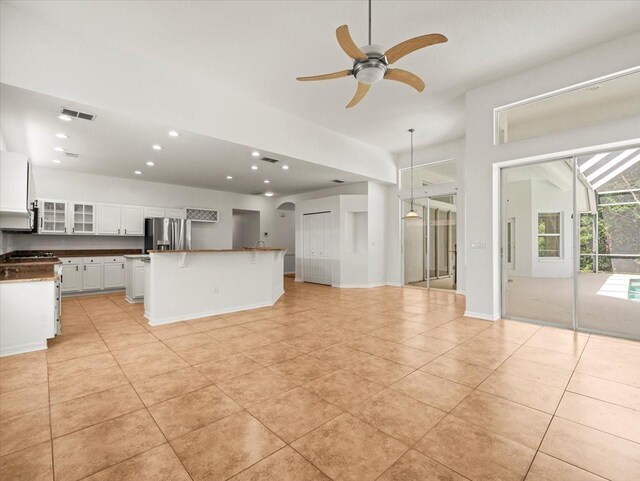 6127 Cezanne Ave, Lutz, FL 33558 - unfurnished living room featuring ceiling fan, recessed lighting, light tile patterned floors, and baseboards