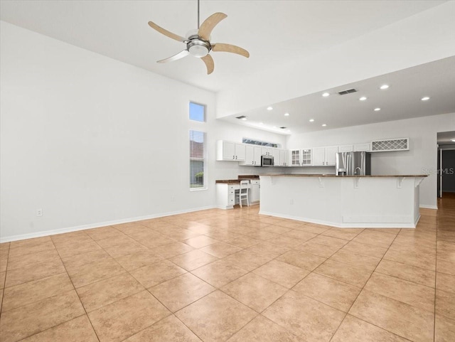6127 Cezanne Ave, Lutz, FL 33558 - unfurnished living room with recessed lighting, light tile patterned flooring, a ceiling fan, and baseboards