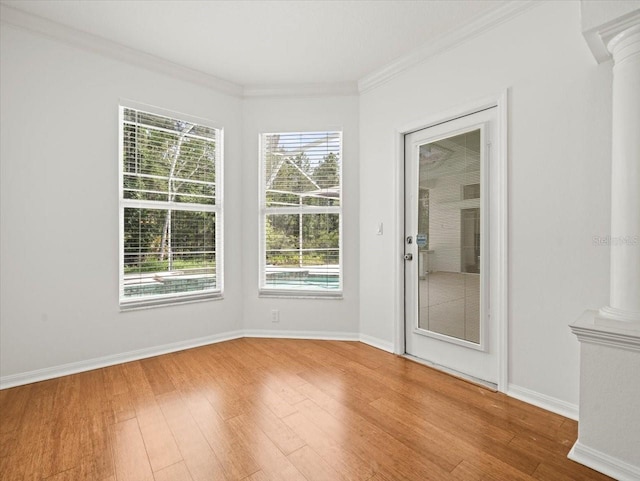 6127 Cezanne Ave, Lutz, FL 33558 - unfurnished room with decorative columns, wood finished floors, ornamental molding, and baseboards