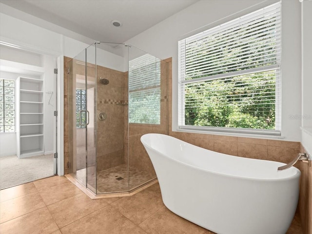 6127 Cezanne Ave, Lutz, FL 33558 - bathroom with a soaking tub, a stall shower, and tile patterned flooring