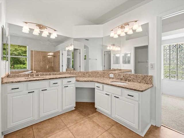6127 Cezanne Ave, Lutz, FL 33558 - full bathroom featuring a chandelier, two vanities, tile patterned flooring, a tile shower, and vaulted ceiling