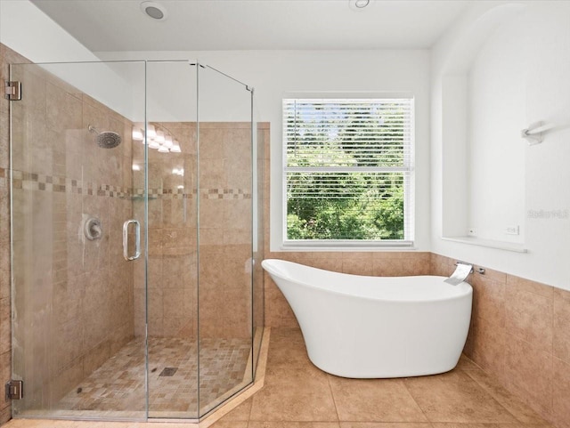 6127 Cezanne Ave, Lutz, FL 33558 - full bathroom with a freestanding bath, a stall shower, tile patterned flooring, and tile walls