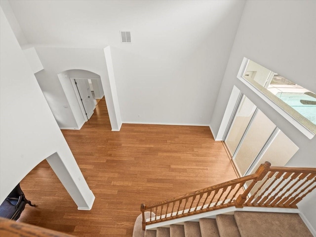 6127 Cezanne Ave, Lutz, FL 33558 - stairs with wood finished floors, arched walkways, and baseboards