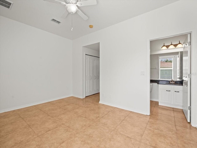 6127 Cezanne Ave, Lutz, FL 33558 - empty room with a ceiling fan, baseboards, light tile patterned floors, and a sink