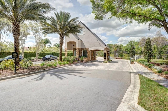 6127 Cezanne Ave, Lutz, FL 33558 - view of asphalt street with curbs, sidewalks, and a gated entry