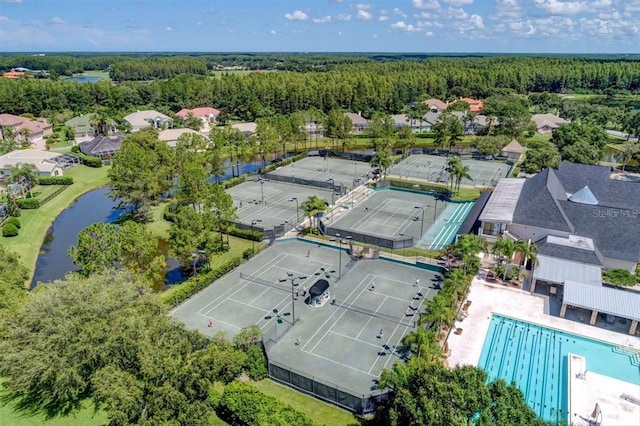 6127 Cezanne Ave, Lutz, FL 33558 - aerial view of residential area with a pool, a forest, and a large body of water