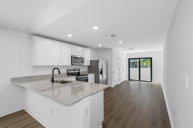 11199 Murraysville Dr, Spring Hill, FL 34609 - kitchen featuring appliances with stainless steel finishes, a sink, baseboards, dark wood-style floors, and light stone countertops