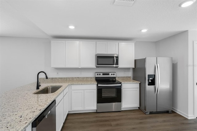 11199 Murraysville Dr, Spring Hill, FL 34609 - kitchen featuring stainless steel appliances, a sink, white cabinets, dark wood-style floors, and recessed lighting