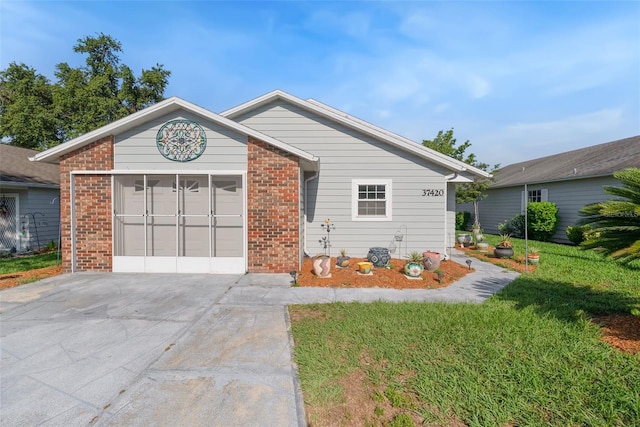 37420 Teaberry Loop, Zephyrhills, FL 33542 - ranch-style house with driveway, brick siding, and a front yard