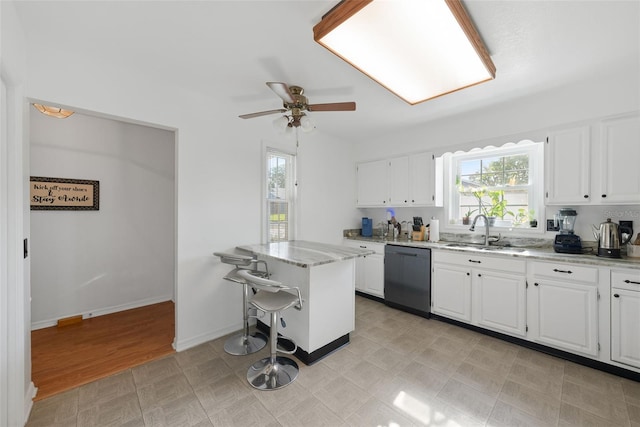 37420 Teaberry Loop, Zephyrhills, FL 33542 - kitchen featuring dishwasher, a sink, healthy amount of natural light, and white cabinetry