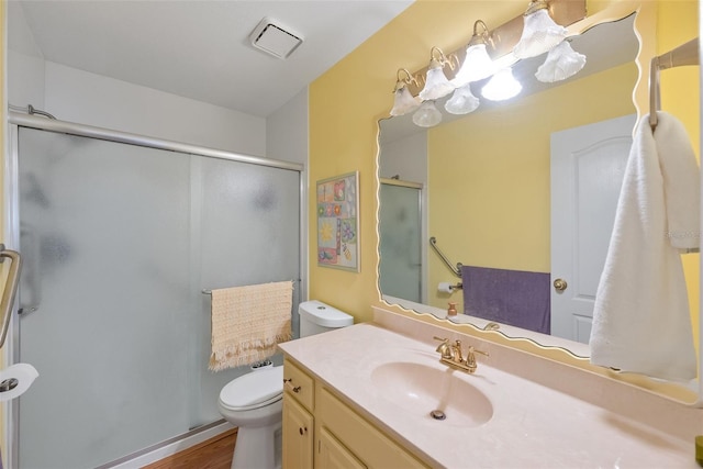 37420 Teaberry Loop, Zephyrhills, FL 33542 - full bath featuring vanity, toilet, a stall shower, and wood finished floors