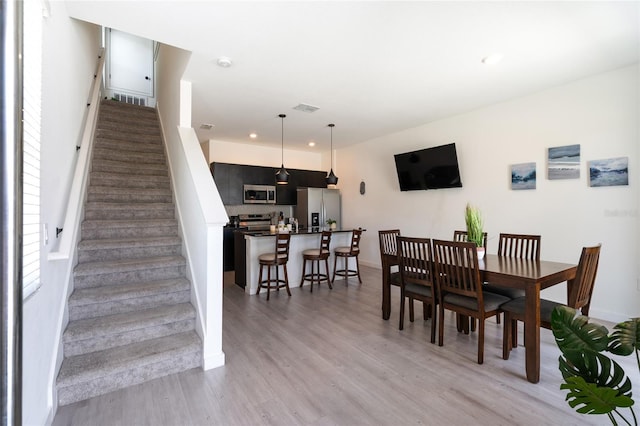 3428 Tranquil Trl, Kissimmee, FL 34747 - dining space with light wood-style floors, recessed lighting, stairway, and baseboards
