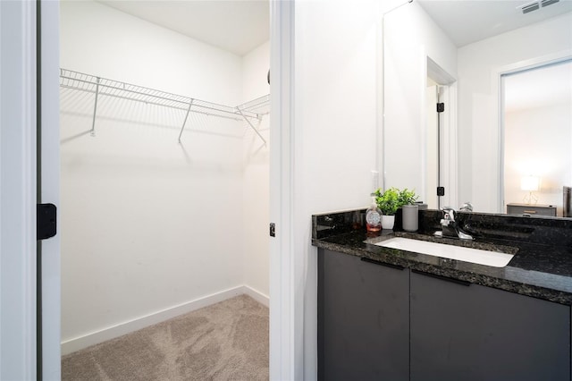 3428 Tranquil Trl, Kissimmee, FL 34747 - bathroom featuring vanity, baseboards, and a walk in closet