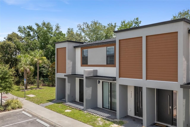3428 Tranquil Trl, Kissimmee, FL 34747 - back of property with stucco siding, uncovered parking, and a yard