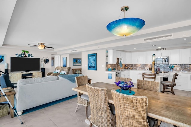 223 Island Way Unit 7F, Clearwater Beach, FL 33767 - dining space featuring a raised ceiling, ceiling fan, and light tile patterned flooring
