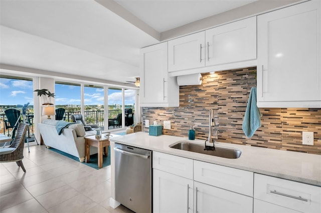 223 Island Way Unit 7F, Clearwater Beach, FL 33767 - kitchen featuring stainless steel dishwasher, a sink, decorative backsplash, white cabinetry, and light tile patterned floors