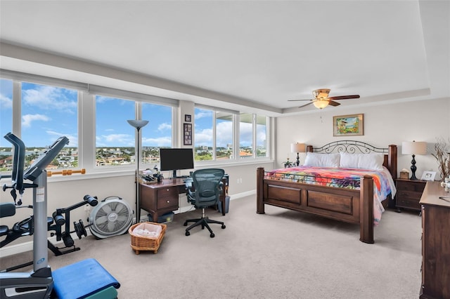 223 Island Way Unit 7F, Clearwater Beach, FL 33767 - bedroom with carpet floors, an office area, baseboards, a raised ceiling, and a ceiling fan