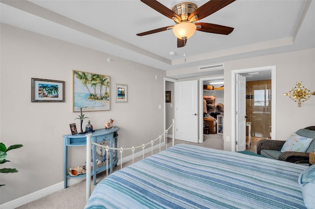 223 Island Way Unit 7F, Clearwater Beach, FL 33767 - carpeted bedroom featuring baseboards, a spacious closet, ensuite bath, a tray ceiling, and a closet