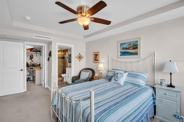223 Island Way Unit 7F, Clearwater Beach, FL 33767 - bedroom with light carpet, a spacious closet, a closet, a raised ceiling, and baseboards
