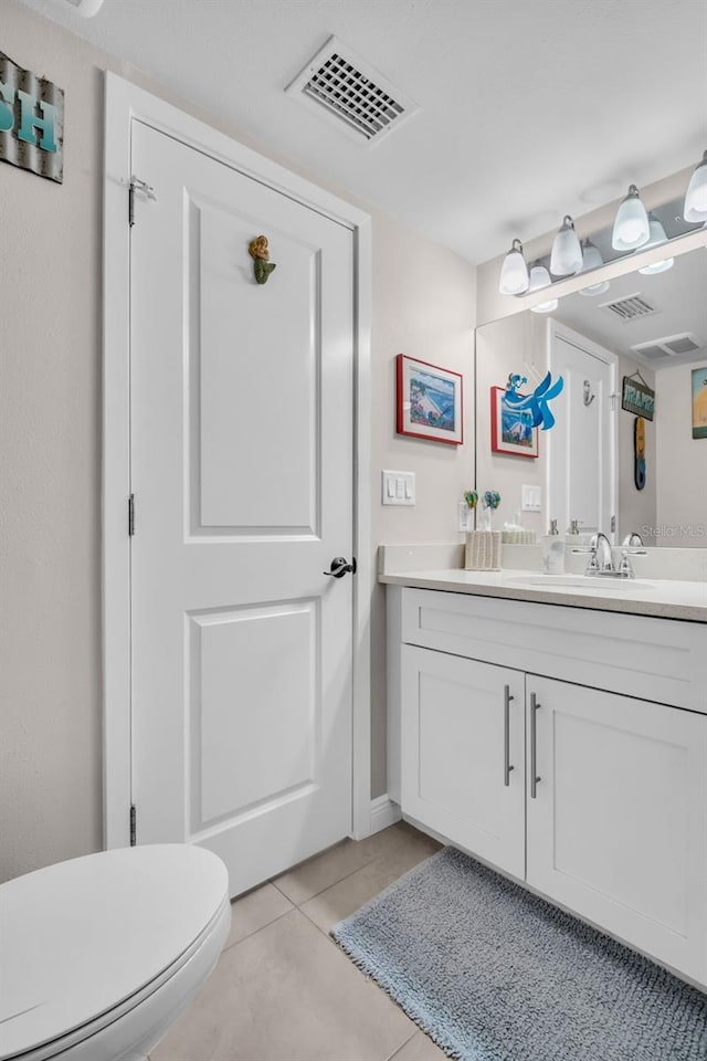223 Island Way Unit 7F, Clearwater Beach, FL 33767 - bathroom featuring vanity, tile patterned floors, and toilet