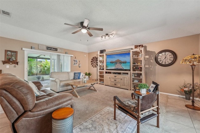 15005 Roundup Dr, Tampa, FL 33624 - living area featuring a ceiling fan, a textured ceiling, tile patterned flooring, and baseboards