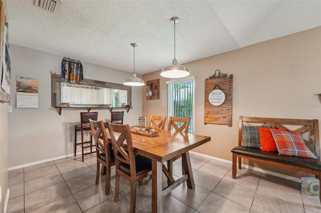 15005 Roundup Dr, Tampa, FL 33624 - dining area with a textured ceiling, baseboards, and light tile patterned flooring