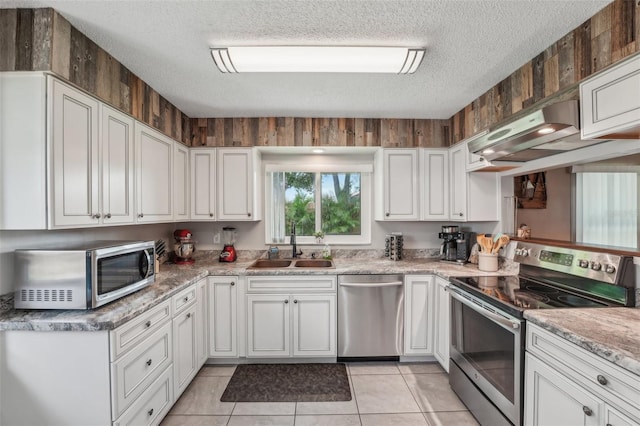 15005 Roundup Dr, Tampa, FL 33624 - kitchen with stainless steel appliances, a sink, a textured ceiling, under cabinet range hood, and white cabinets