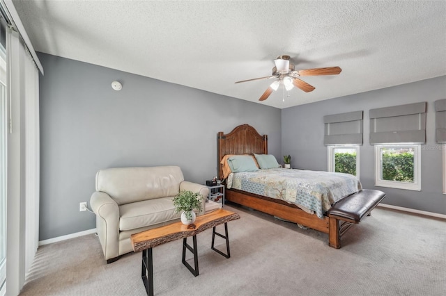 15005 Roundup Dr, Tampa, FL 33624 - bedroom with light carpet, a textured ceiling, baseboards, and ceiling fan