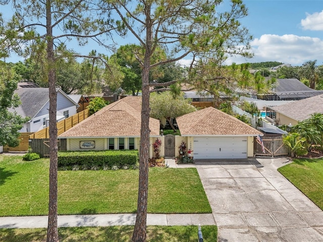 15005 Roundup Dr, Tampa, FL 33624 - ranch-style home featuring a gate, concrete driveway, an attached garage, and a residential view