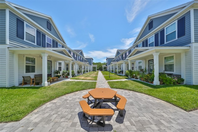 6619 S Manhattan Ave Unit 1, Tampa, FL 33616 - surrounding community with a patio area, a residential view, and a lawn