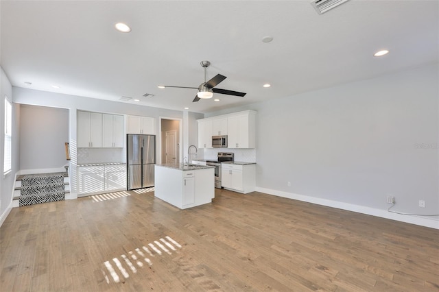 6619 S Manhattan Ave Unit 1, Tampa, FL 33616 - unfurnished living room with a ceiling fan, a sink, baseboards, light wood-style floors, and recessed lighting