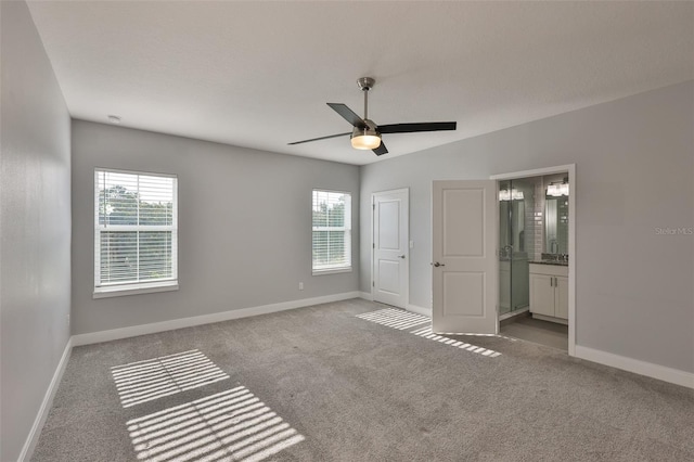 6619 S Manhattan Ave Unit 1, Tampa, FL 33616 - unfurnished bedroom with multiple windows, carpet flooring, and baseboards