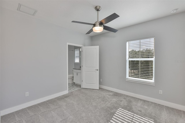 6619 S Manhattan Ave Unit 1, Tampa, FL 33616 - unfurnished bedroom with carpet flooring, connected bathroom, baseboards, and a ceiling fan