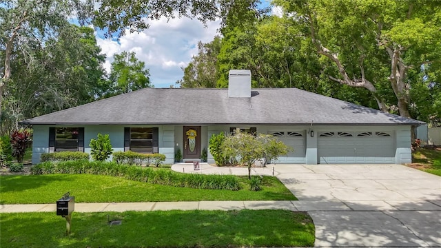 1014 Sylvia Ln, Tampa, FL 33613 - ranch-style house featuring an attached garage, driveway, a chimney, a front yard, and roof with shingles