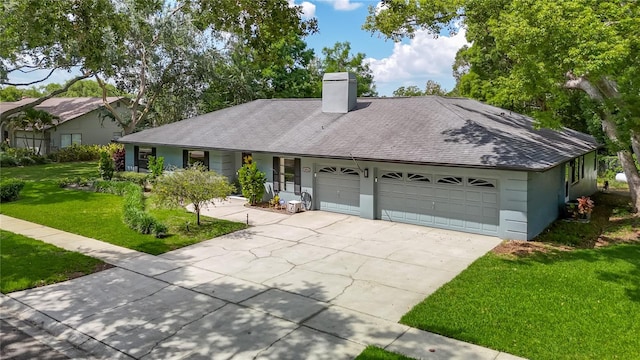 1014 Sylvia Ln, Tampa, FL 33613 - ranch-style house with an attached garage, a front lawn, a chimney, driveway, and stucco siding
